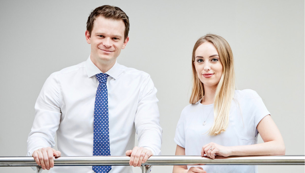 Male and female colleagues, Dr Harrison Evans and Chelsea Hardy smiling