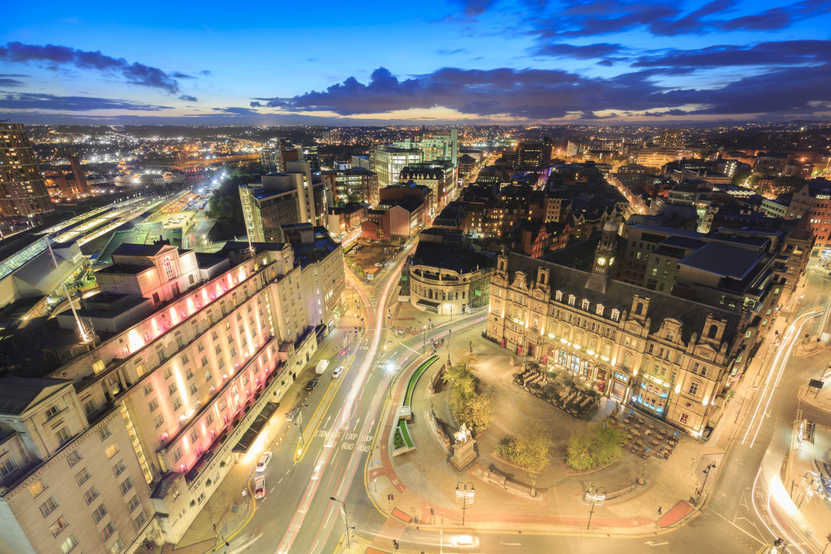 High angle view of hotels, restaurants and bars in the centre of Leeds. Leeds City Square and panoramic night view of skyline.
