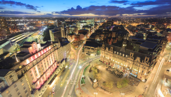 High angle view of hotels, restaurants and bars in the centre of Leeds. Leeds City Square and panoramic night view of skyline.