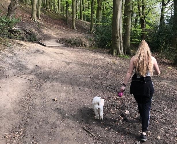 Emma Lister, Nexus Marketing & Events Executive walking her dog through the woods