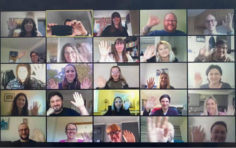 Screenshot of the OneMedical Group team logged in for a video call, all waving to camera