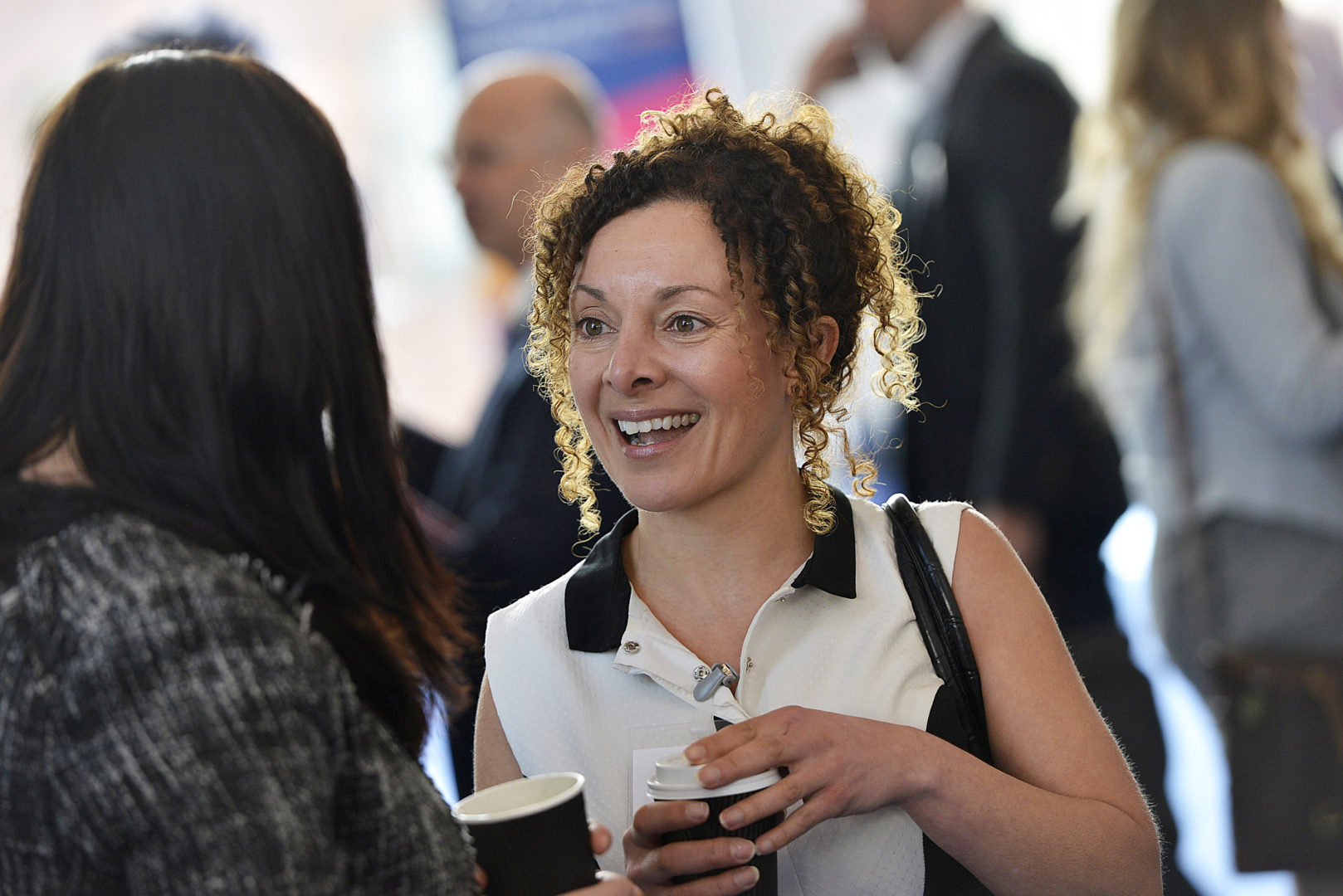 Image of Melanie Ellyard, Senior Manager for Yorkshire, Humber and Tees Valley, UK Network for the British Business Bank stood conversing with a person over a coffee