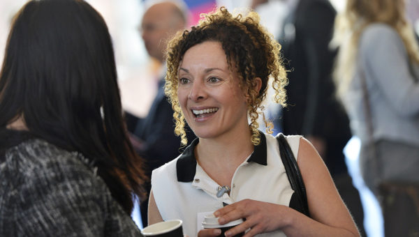 Image of Melanie Ellyard, Senior Manager for Yorkshire, Humber and Tees Valley, UK Network for the British Business Bank stood conversing with a person over a coffee