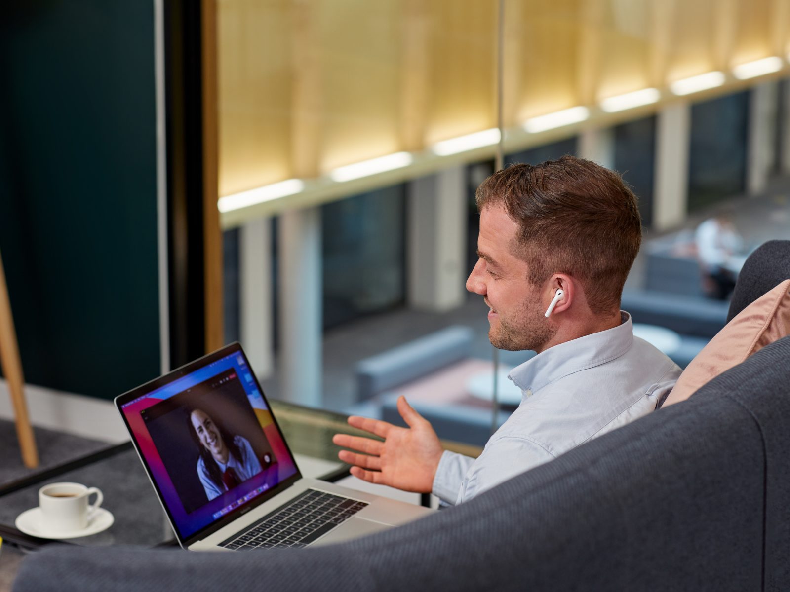 A man answering a video call on his laptop