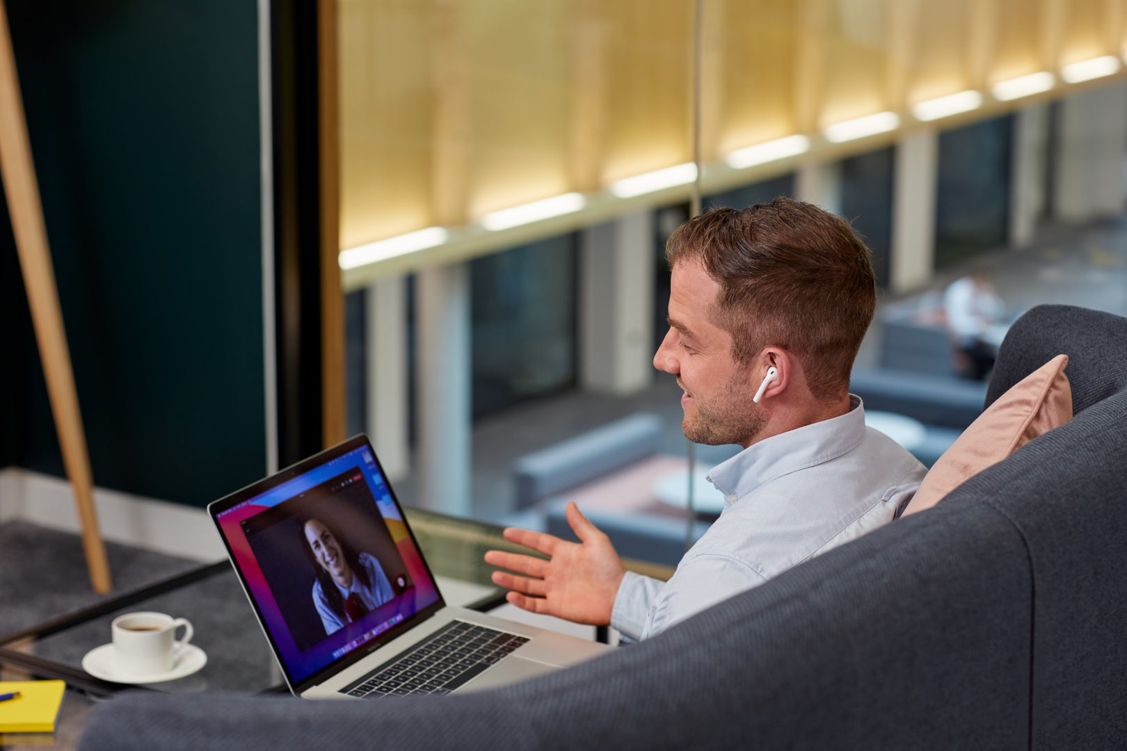 A man answering a video call on his laptop
