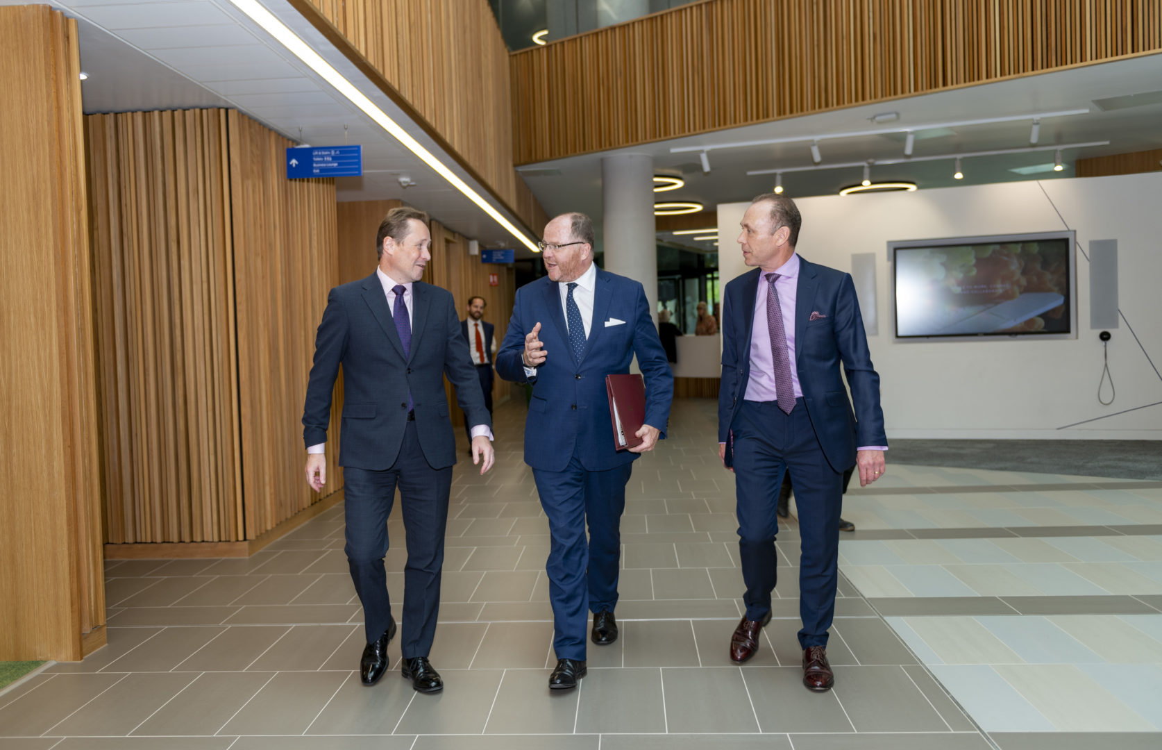 Image of people walking in Nexus building. From left, Professor Nick Plant, Science Minister George Freeman and Dr Martin Stow at Nexus (credit University of Leeds)
