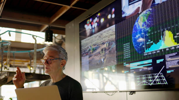 A man talking in front of a powerpoint on the climate.