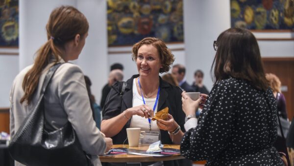 A woman eating breakfast at an event.