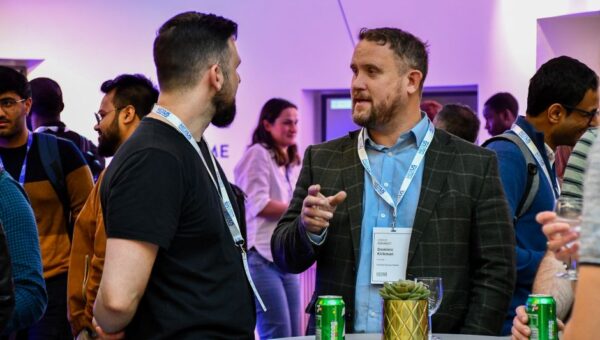 Two men in conversation at an event