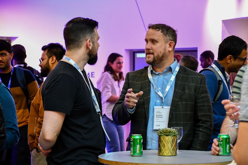 Two men in conversation at an event