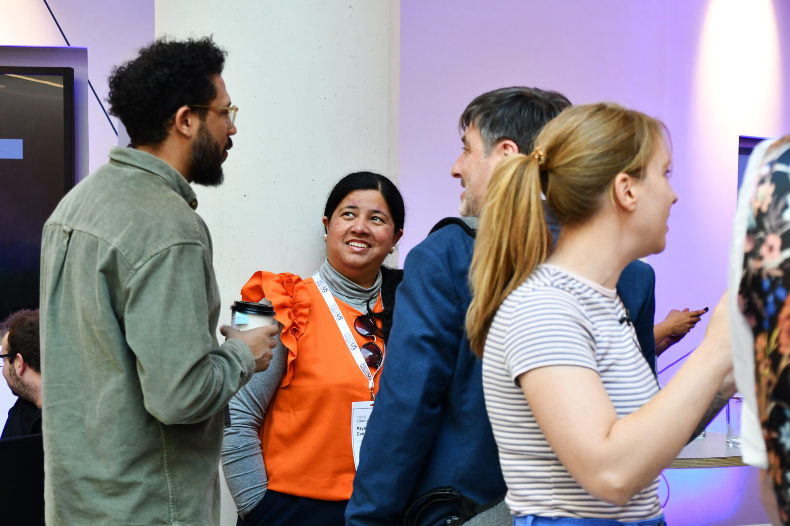 People smiling and networking at Nexus Connect.