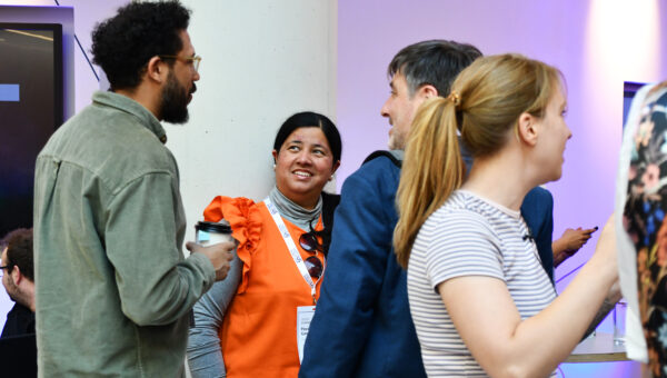 People smiling and networking at Nexus Connect.