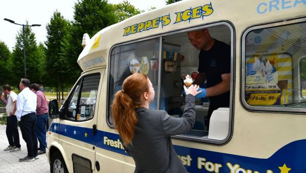 Woman taking ice-cream from Ice-cream van