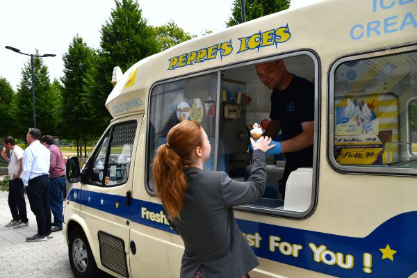 Woman taking ice-cream from Ice-cream van