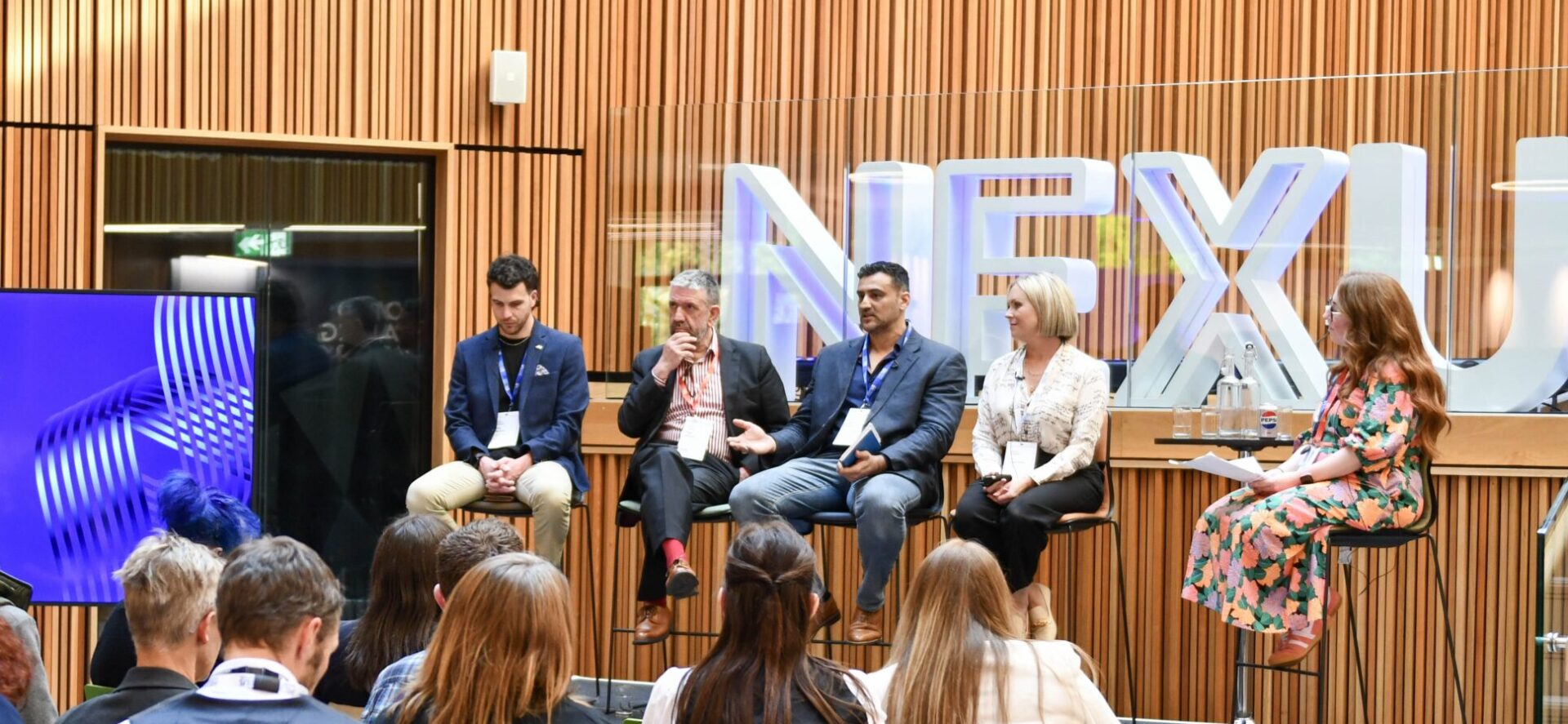 A panel at Nexus Connect in front of an audience
