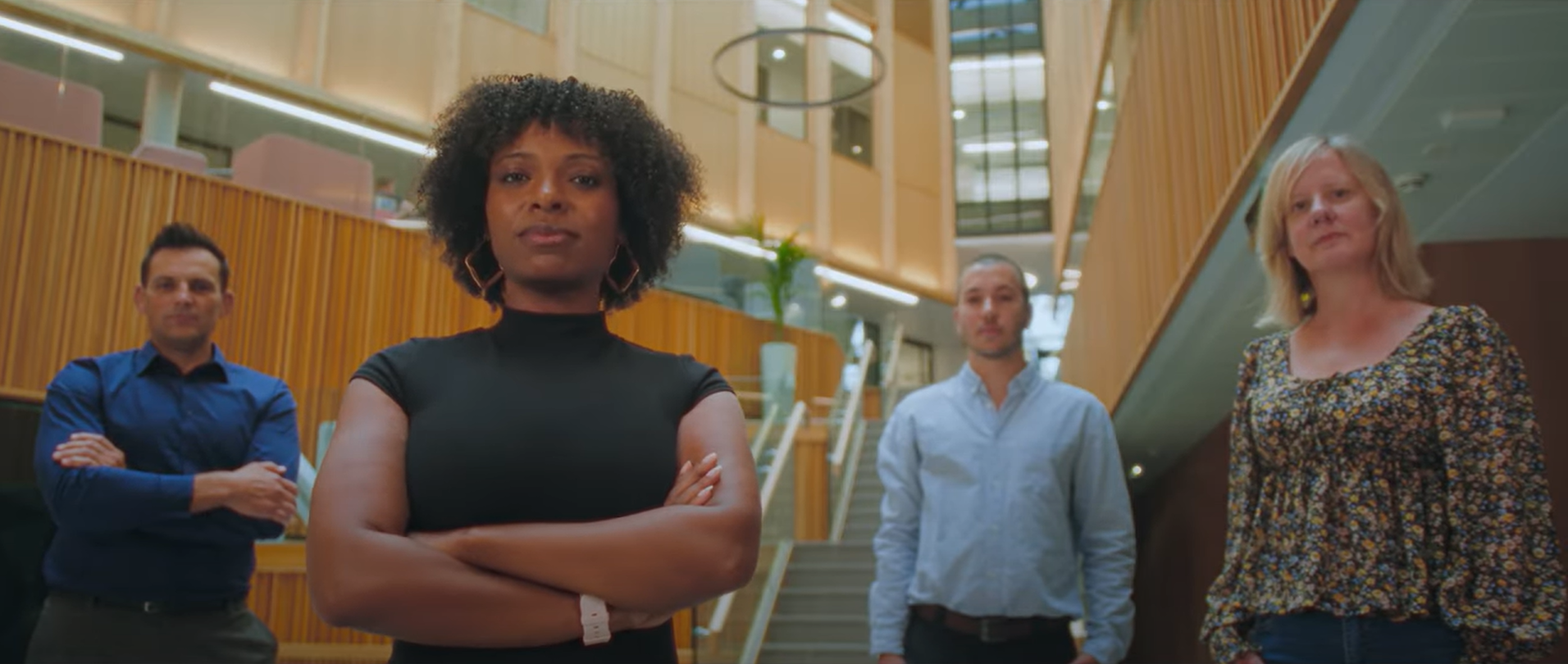 Four people stood in the Nexus atrium, looking to camera.