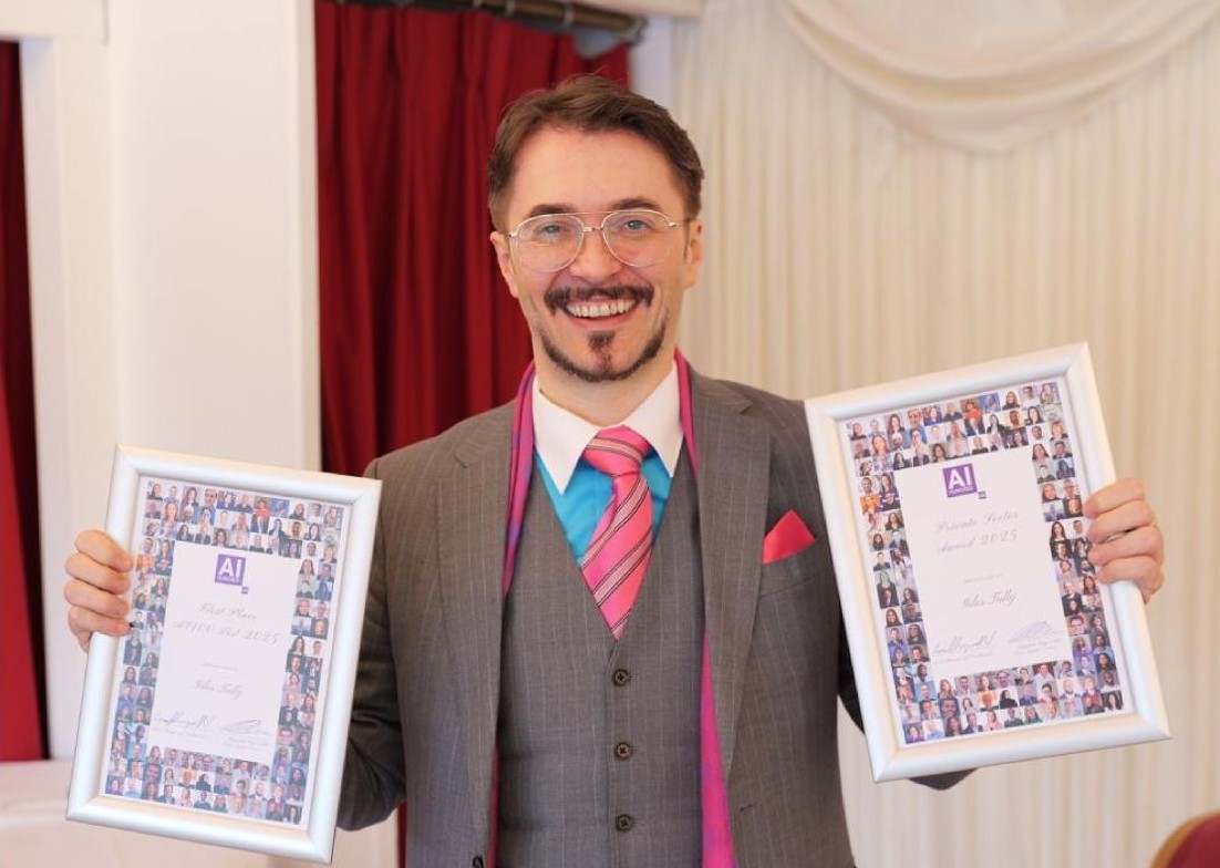 Giles Tully holding awards
