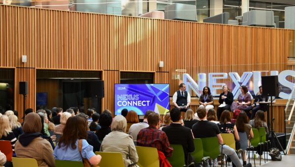 Seated group listening to Nexus Connect 15 panel
