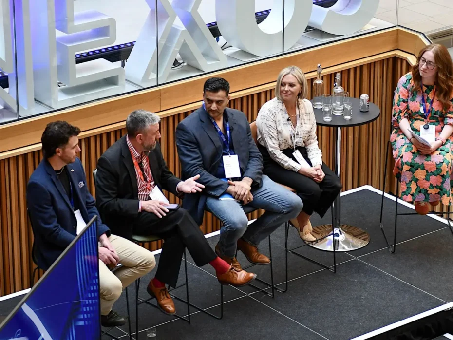 5 panelists sitting on a stage