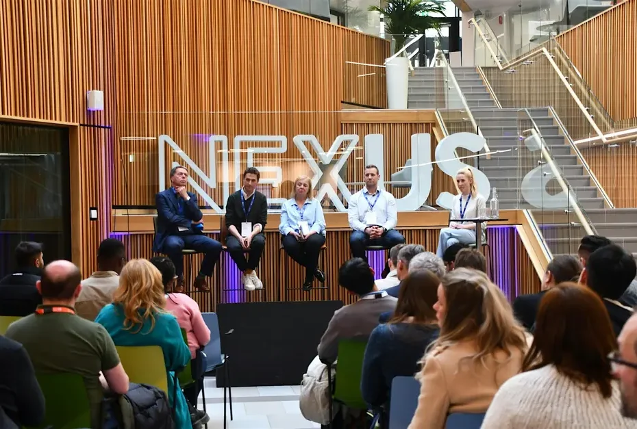 Panelists talking to an audience